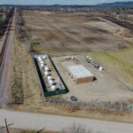 Aerial view of a Starlink ground station in Merrillan, Wisconsin, with satellite antennas inside a fenced compound. Illustrative photograph, not the Polish site.