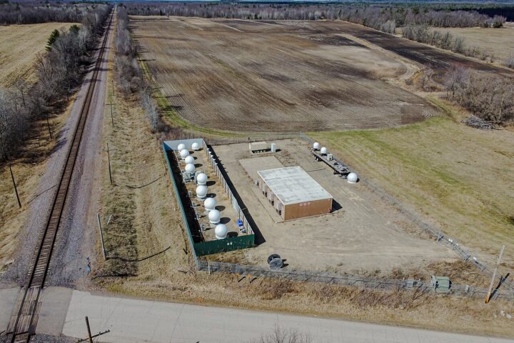 Aerial view of a Starlink ground station in Merrillan, Wisconsin, with satellite antennas inside a fenced compound. Illustrative photograph, not the Polish site.